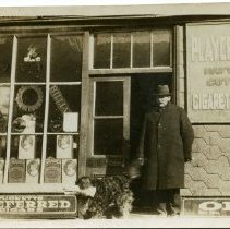 Man Standing Outside Cigarette and Billiards Store